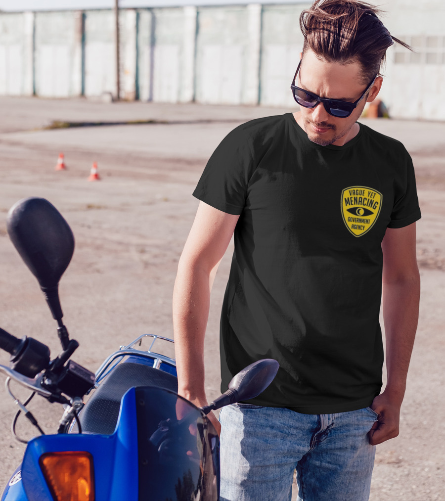 Vague Yet Menacing Government Agency Yellow Badge With Eye T-Shirt