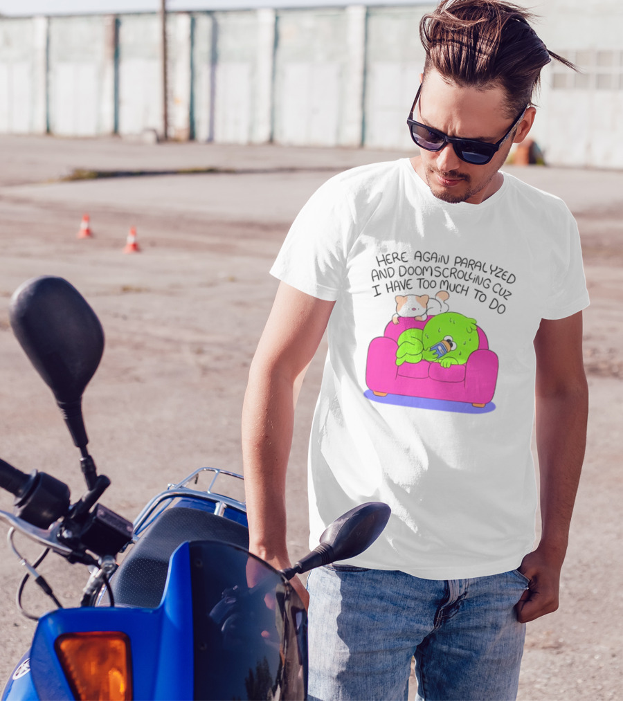Here Again Paralyzed And Doomscrolling Cuz I Have Too Much To Do Quirky Green Figure Relaxing On Pink Couch With Cute Dog T-Shirt