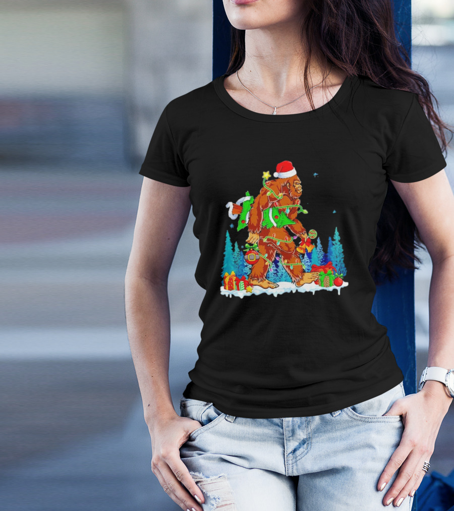 Bigfoot Santa Hugging Christmas Tree With Gifts And Snow Scene T-Shirt